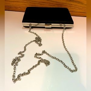 Black Satin clutch/purse. Silver tone removable chain strap.